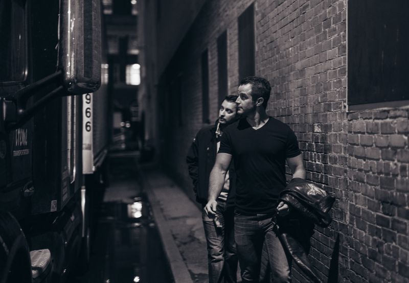 Black and white alley walk to venue beside bus