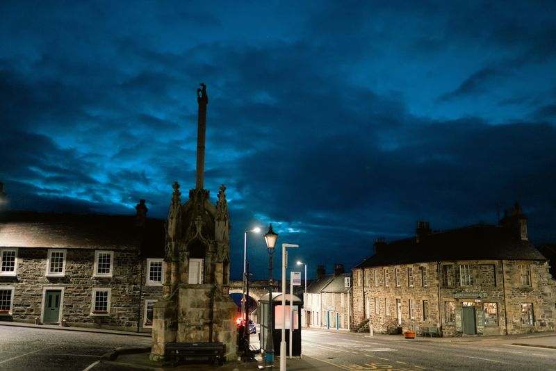 Blue hour market cross and stone houses, moody sky