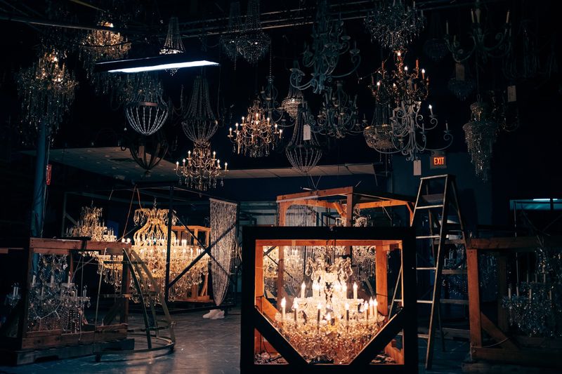 Chandelier warehouse, crated fixture glowing below ceiling