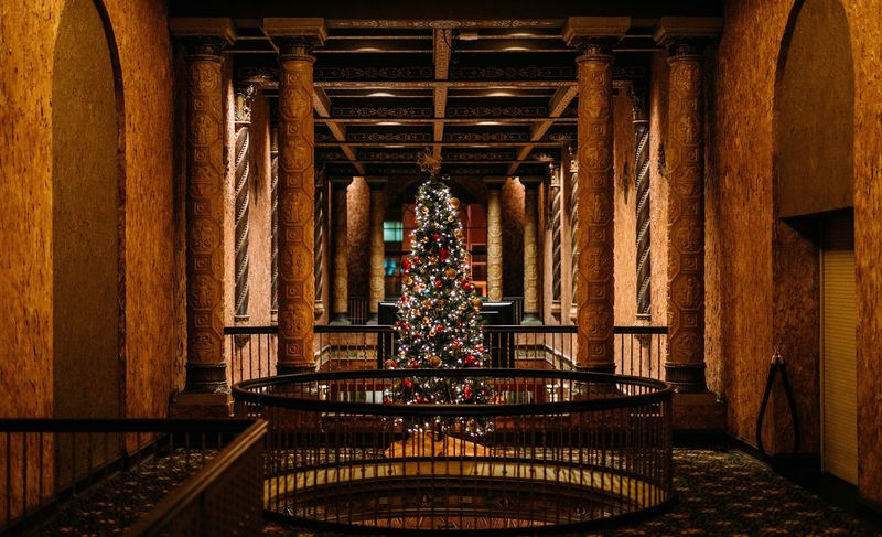 Ornate theater lobby columns, Christmas tree center