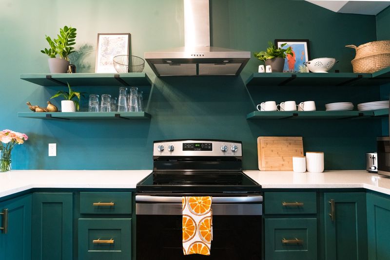 Range hood shelves with orange towel on oven