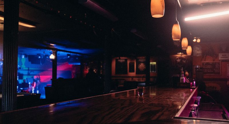 Empty dive bar in blue and amber light