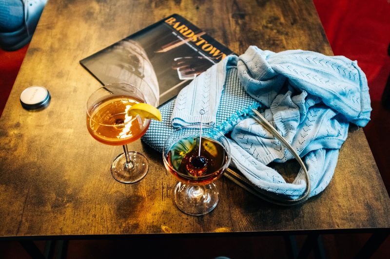 Two cocktails on a worn table, Bardstown