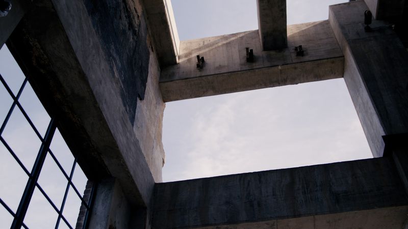 Looking up through concrete shaft to open sky
